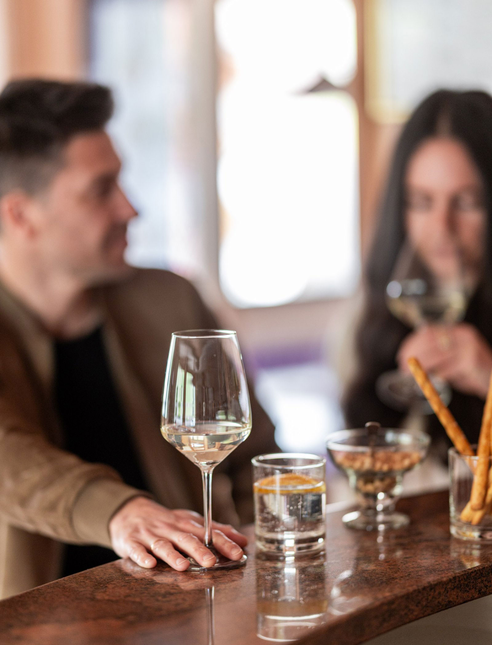 Enjoy a glass of white wine at the bar